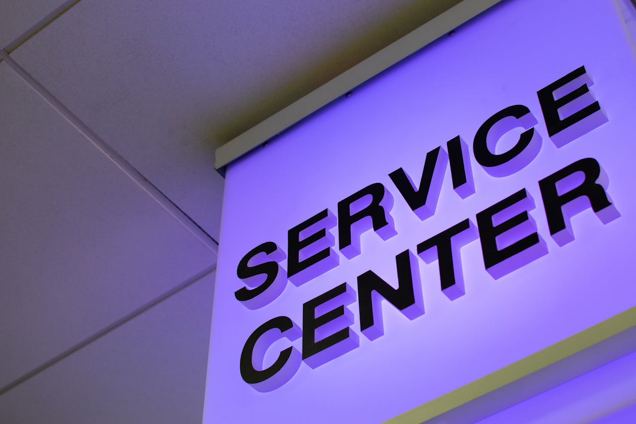 services-03 Close-up of a modern illuminated Service Center sign in a building interior.